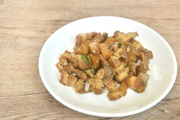 Stir fried slice fat pork belly with pineapple and black ear mushroom with soy sauce on plate