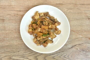 Stir fried slice fat pork belly with pineapple and black ear mushroom with soy sauce on plate