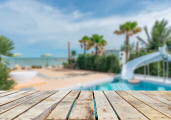 Wooden table top on the beach or sea. swimming pool Party on the beach  sunshine time concept.For montage product display or design key visual layout.View of copy space.