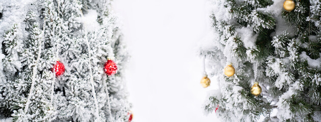 Christmas tree with decorative balls covered with snow