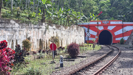 Railway tunnel in nature near station path
