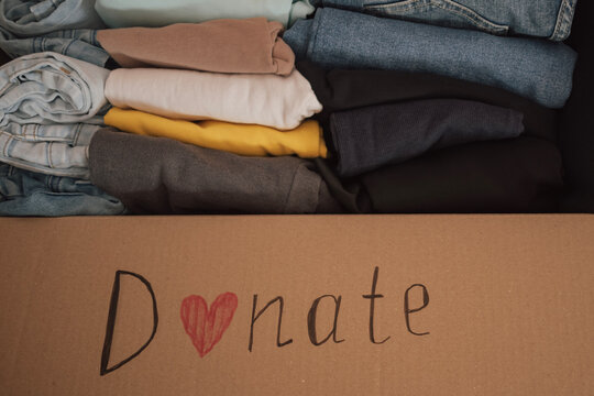 Box filled with neatly folded clothes ready for donation at a local charity for those in need
