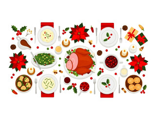 Overhead view of a festive Christmas dinner table setting with ham, side dishes, poinsettias, candles, and wrapped gifts, arranged on a white background.