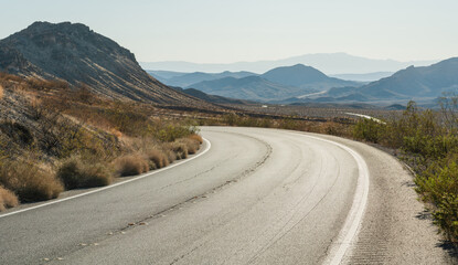 Curving desert highway through mountain range