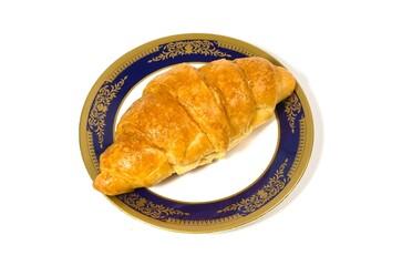 Golden brown butter croissant isolated on white background.Croissant placed on a plate.