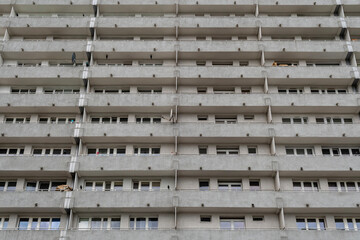 Concrete apartment block facade with repetitive balconies &mdash; urban residential architecture