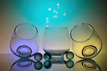 Three glasses with glass balls and colorful background