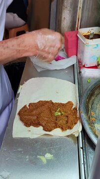 Traditional Turkish Street Food Chef Preparing Cig Kofte Wrap in Istanbul