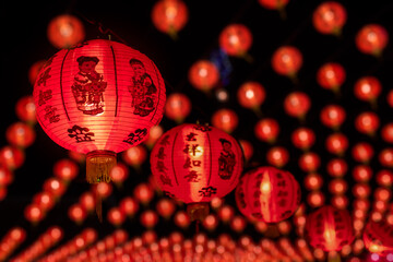 Group of red paper Chinese lanterns with blessing word mean happy, healthy and wealth. Background for Chinese New Year greeting theme. Selective focus.