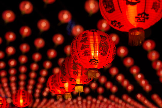 Group of red paper Chinese lanterns with blessing word mean happy, healthy and wealth. Background for Chinese New Year greeting theme. Selective focus.