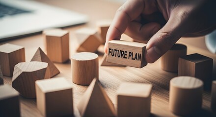 Hand placing a wooden block with future plan text among geometric shapes