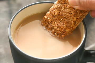 Granola bar in cup of tea. Healthy drink and snack.
