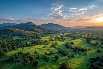 Lush green valley with hills at sunset, beautiful landscape view. Ideal for travel, tourism, or nature related content or advertising.