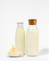 Fresh Milk, Kefir, and Cubes of Butter on White Background