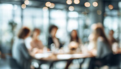 Blurred Image Of Professional Women Collaborating At Conference Roundtable Discussion In Contemporary Meeting Room. Defocused Photograph.