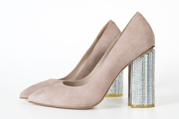 Stylish beige suede womens pumps with decorative silver block heels studio product shot