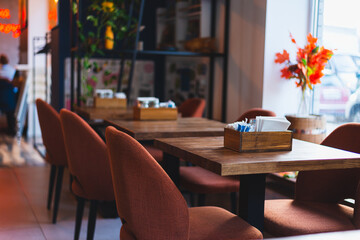 A cozy cafe restaurant in warm colors overlooking the window. warm orange and brown colors prevail. High quality photo