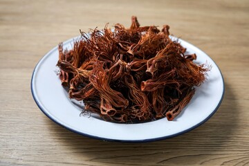 Close up of dried red cotton tree flowers (Kapok flowers) Heap of dried Dok Ngiew , Northern Thai food ingredient.