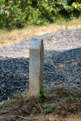 Concrete Boundary Marker Post in Outdoor Setting