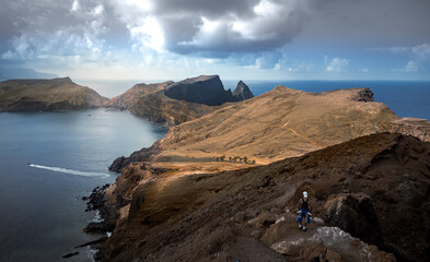 Dramatic volcanic cliffs and serene ocean view at Ponta de S&atilde;o Louren&ccedil;o, Madeira Island, Portugal &ndash; panoramic coastal landscape with sailboats, hiking trails, and wild natural beauty.