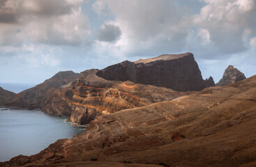 Dramatic volcanic cliffs and serene ocean view at Ponta de São Lourenço, Madeira Island, Portugal – panoramic coastal landscape with sailboats, hiking trails, and wild natural beauty.