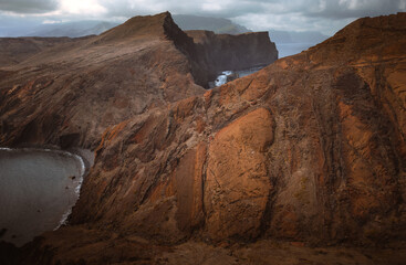 Dramatic volcanic cliffs and serene ocean view at Ponta de S&atilde;o Louren&ccedil;o, Madeira Island, Portugal &ndash; panoramic coastal landscape with sailboats, hiking trails, and wild natural beauty.