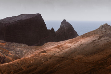 Dramatic volcanic cliffs and serene ocean view at Ponta de S&atilde;o Louren&ccedil;o, Madeira Island, Portugal &ndash; panoramic coastal landscape with sailboats, hiking trails, and wild natural beauty.