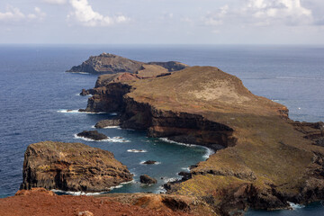 Dramatic volcanic cliffs and serene ocean view at Ponta de S&atilde;o Louren&ccedil;o, Madeira Island, Portugal &ndash; panoramic coastal landscape with sailboats, hiking trails, and wild natural beauty.