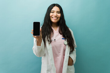 Female doctor showing smartphone screen for telehealth app