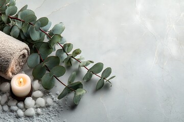 A serene spa composition featuring eucalyptus, a lit candle, and bath salts on a tranquil marble background, perfect for relaxation.