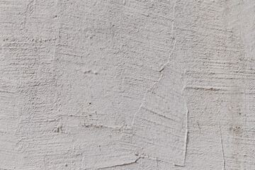 Textured white plaster wall with visible cracks and patterns