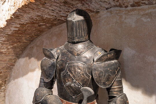 Medieval knight armor display in stone archway setting
