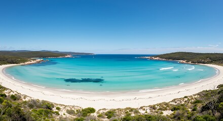 Obraz premium Panoramic view of a pristine beach with turquoise water, white sand and blue sky