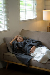 Obraz premium senior woman feels feverish and unwell while resting at home