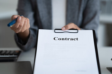 Lawyer preparing to sign a contract reading documents