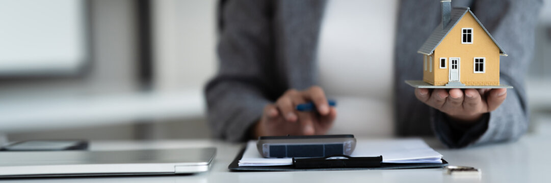 consultant calculates property valuation and house loan contract in office
