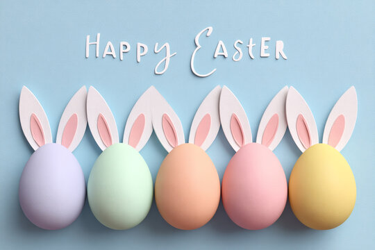 row of pastel easter eggs with bunny ears and happy easter text - Powered by Adobe
