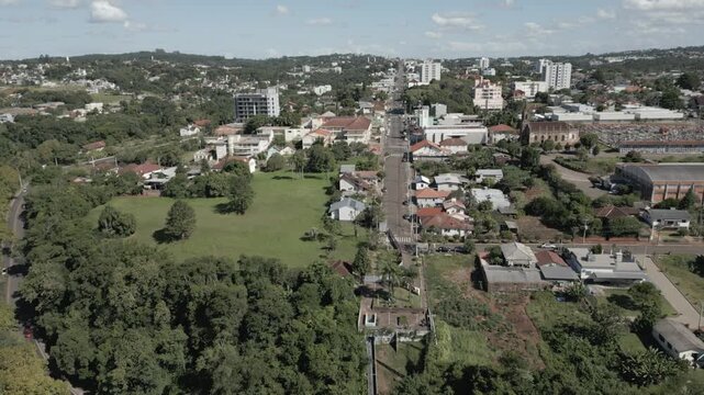 Drone footage showing Ivoti&rsquo;s main avenue stretching through the town, with residential homes and green spaces on a bright day.