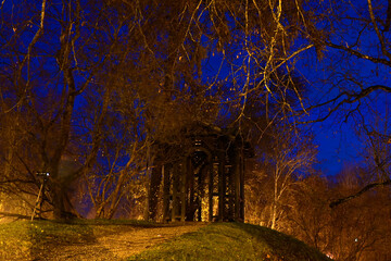colorful and bright autumn landscape from the city park in dark autumn, illuminated park, beautiful lights, Cesis, Latvia