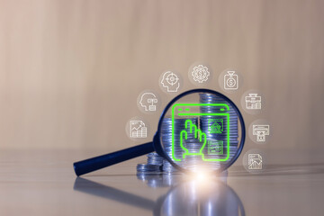 Magnifying glass highlighting digital finance and investment icons over stacked coins, symbolizing online banking, financial growth, and data analysis.