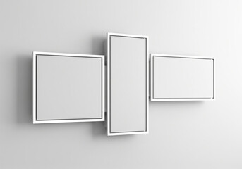 Contemporary triptych display with blank white screens on a light gray wall, offering a modern and minimalist aesthetic for signage or art