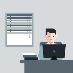 Man working at desk focused on computer screen in office environment.