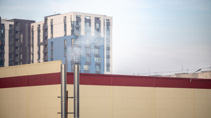 Smoke from industrial chimneys near residential buildings
