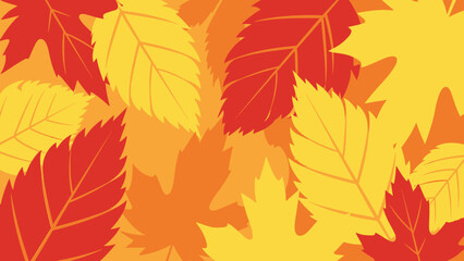 Obraz premium A vibrant and colorful abstract background featuring overlapping autumn leaves in shades of red, orange, and yellow.