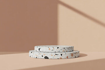 Minimalist terrazzo pedestal display with soft shadows and warm background