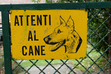dog warning sign on a fence