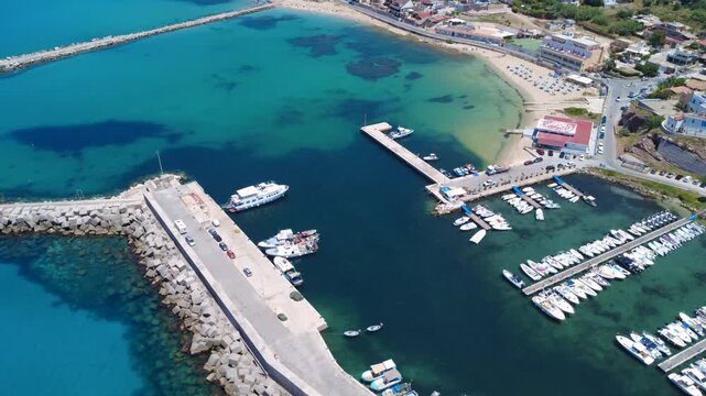 Boats Docked in a Beautiful Harbor Near a Sandy Beach on a Sunny Day in a Coastal Town. Terrasini, Sicily, Italy