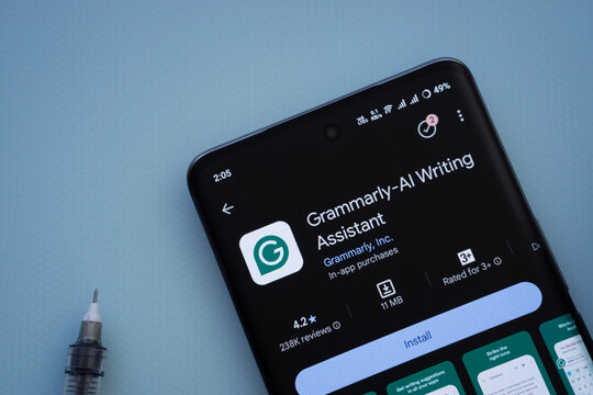 Dhaka, Bangladesh- 29 May 2025: On a blue surface, a smartphone displays the Grammarly app within the Google Play Store.