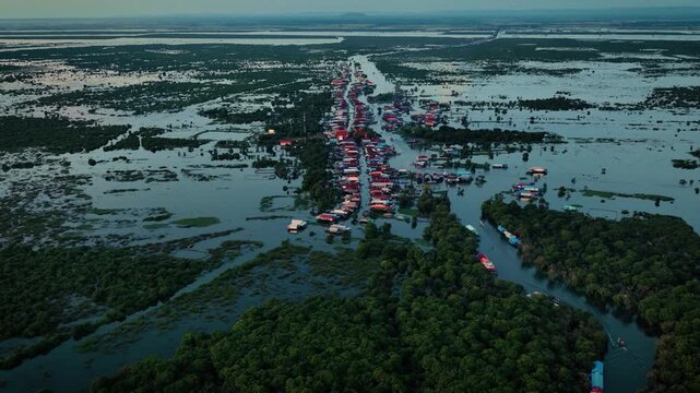 Kampong Phluk floating village with stilt houses on Tonle Sap lake in Cambodia.
