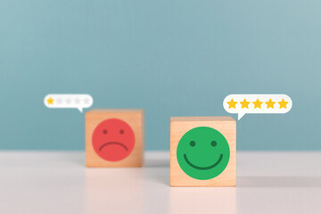 Excellent, satisfaction, service rating and positive feedback concept. Wooden cube with smile face emoticon indicate highest satisfaction service. 5 star satisfaction